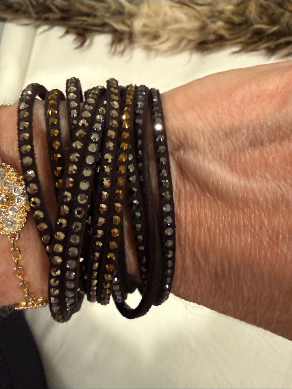 Black leather bracelet with rose gold, gold and silver stones.